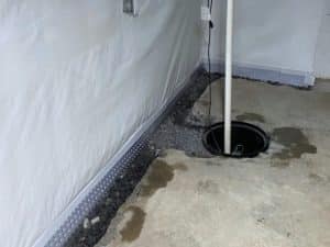 Installation of a sump pit and Zoeller pump during basement waterproofing in Stephens City, VA.