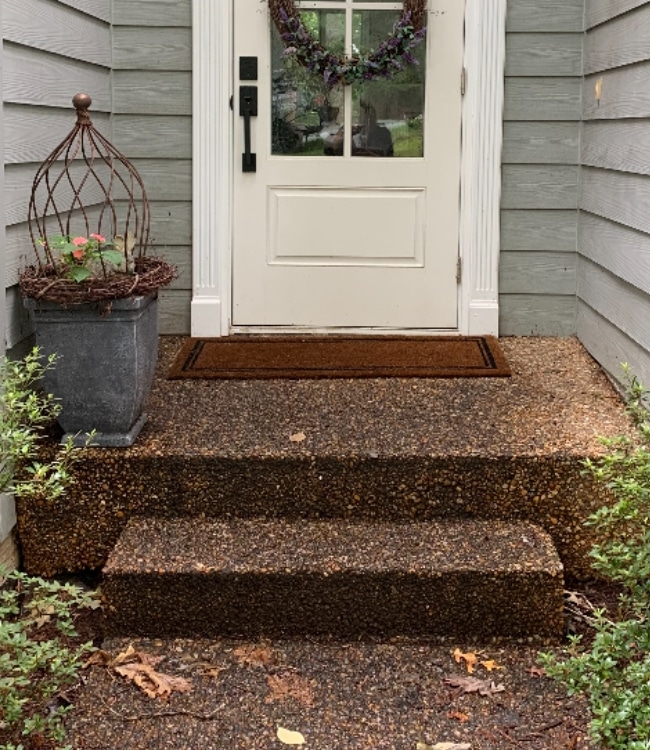 Unlevel porch steps showing a sunken porch problem, highlighting the need for sunken concrete porch repair in Northern Virginia.