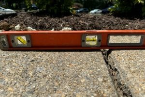 Uneven sidewalk with noticeable height differences, showing signs of uneven sidewalks and walkways in Bristow, VA.