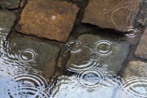 Water pooling near the porch base, a potential soil erosion and drainage issues, a common sign of a sunken porch in Bristow, VA.