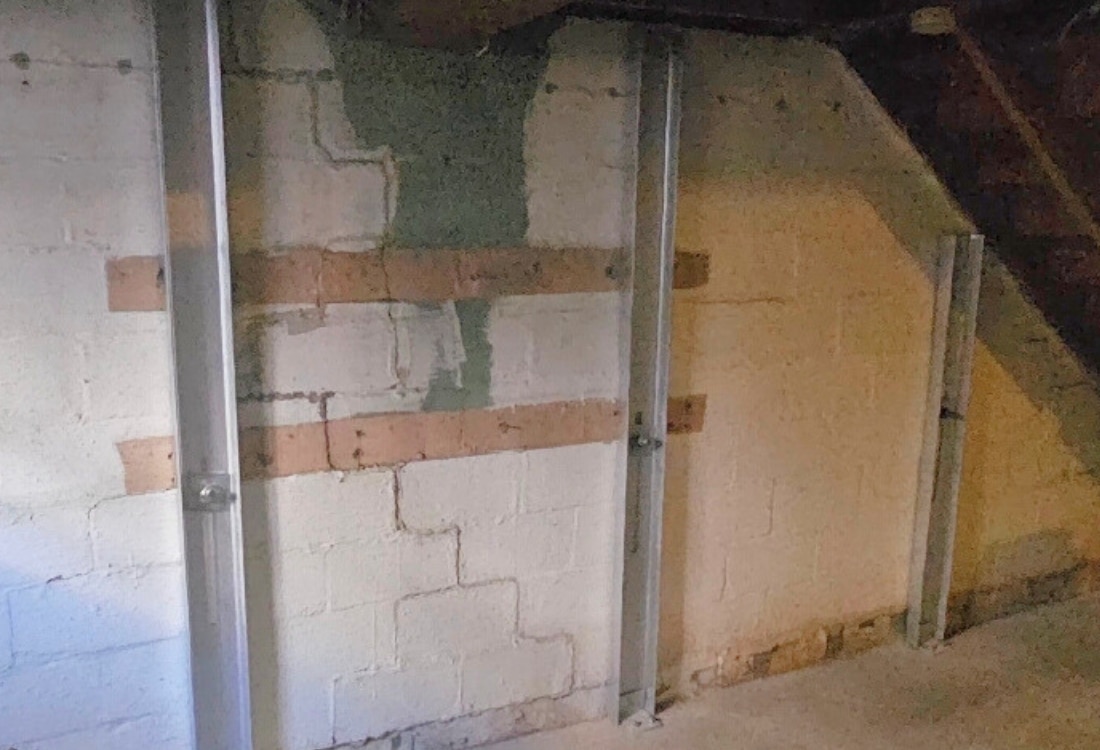 Stabilized cinder block basement walls after the successful installation of foundation wall anchors in White Post, VA