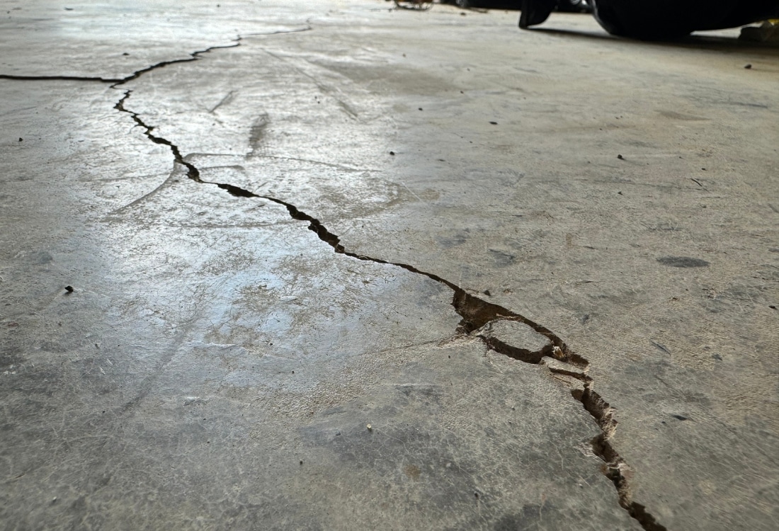 Cracked and shifted concrete slab showing uneven surfaces and damage that needs concrete repair in Winchester, VA.