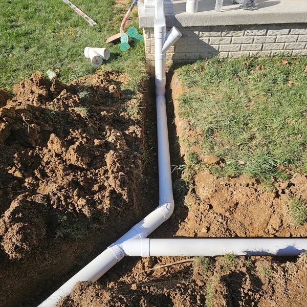 Installed new drainage pipes, a solution to the old, poor drainage system in Berkeley, WV, preventing basement water seepage.