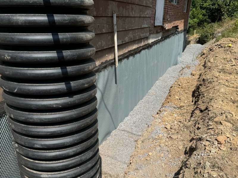 Exterior drainage system installed to redirect water and protect the repaired crumbling foundation in Martinsburg, WV .