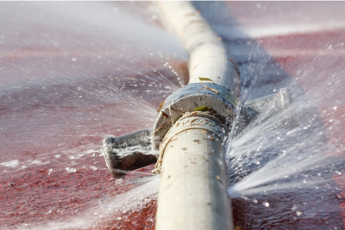 Bursting plumbing pipe, illustrating poor drainage system in Reston, VA, leading to basement water seepage.