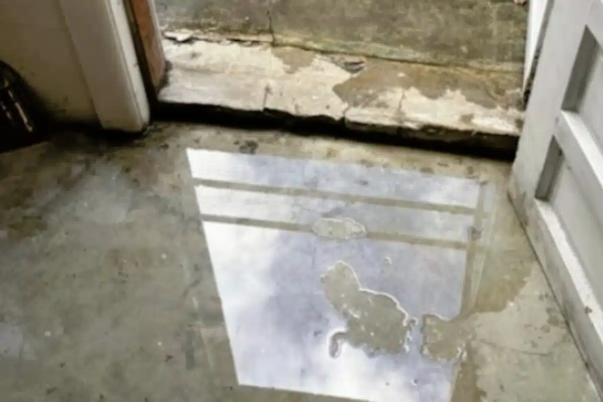 Pooling water on the basement floor, a sign of water damage after excessive rainfall in Stephens City, VA.