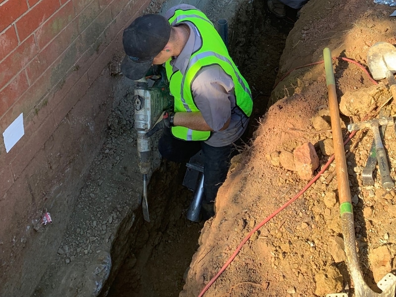 LUX team installing push piers to stabilize the crumbling foundation and chimney in Charles Town, WV.