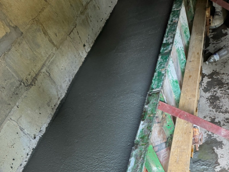 New footing and concrete block wall reinforcing the crumbling foundation in Front Royal, VA, for structural integrity.