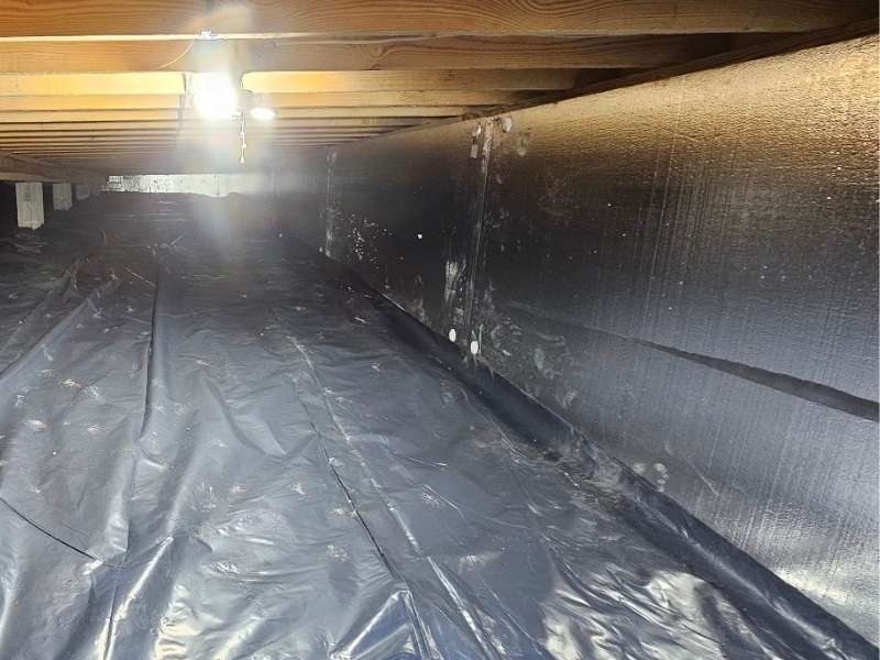 Crawl space vapor barrier and insulation installed in Rileyville, VA, to control moisture and prevent water leaking into the basement.