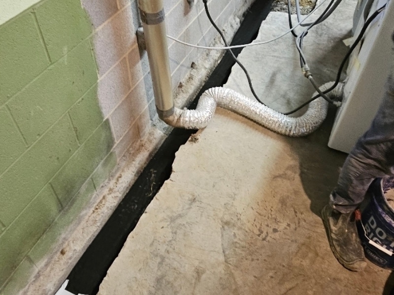 Under-slab drainage system installation in Strasburg, VA, for a basement to prevent water intrusion and keep the area dry.