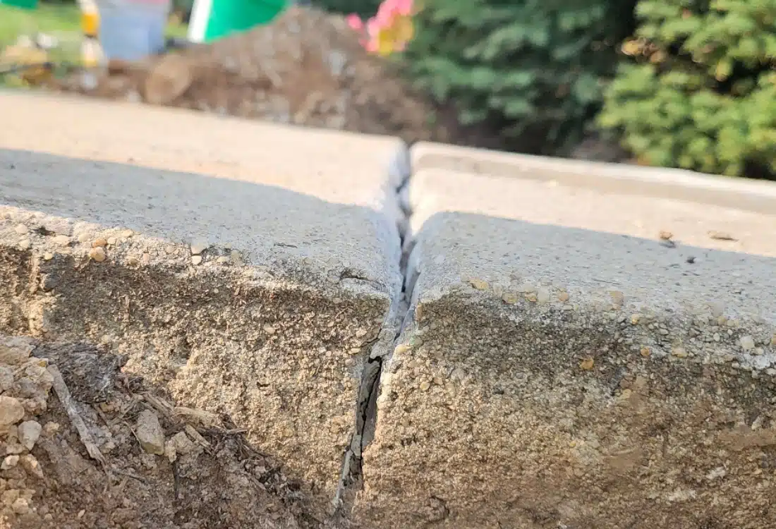 Damaged and uneven sidewalk creating a tripping hazard before concrete sidewalk repair in Alexandria, VA.