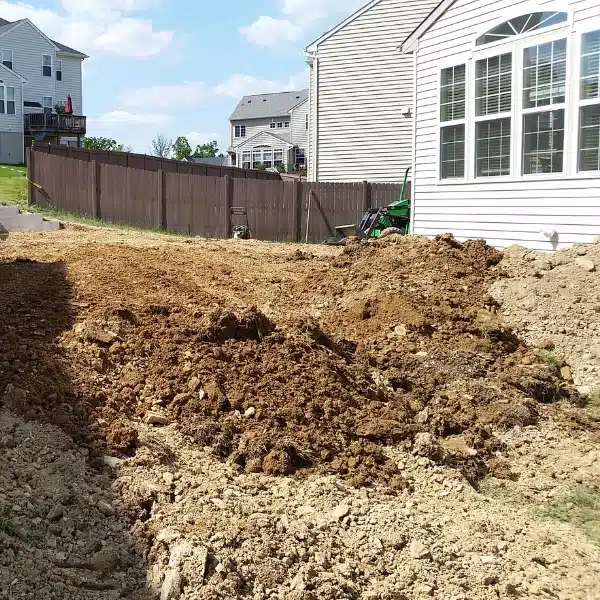 Regraded lawn sloping away from home to direct water away from the foundation and prevent slope failure in Flint Hill, VA.