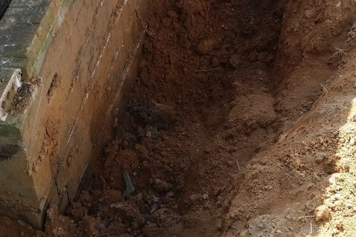 Improper grading on a sloping property by human activities causing slope erosion in Clear Brook, VA.