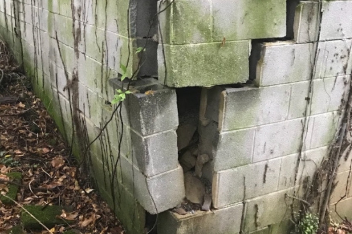 Large foundation cracks from improper installation, showing poor construction in Manassas, VA, caused basement water damage.