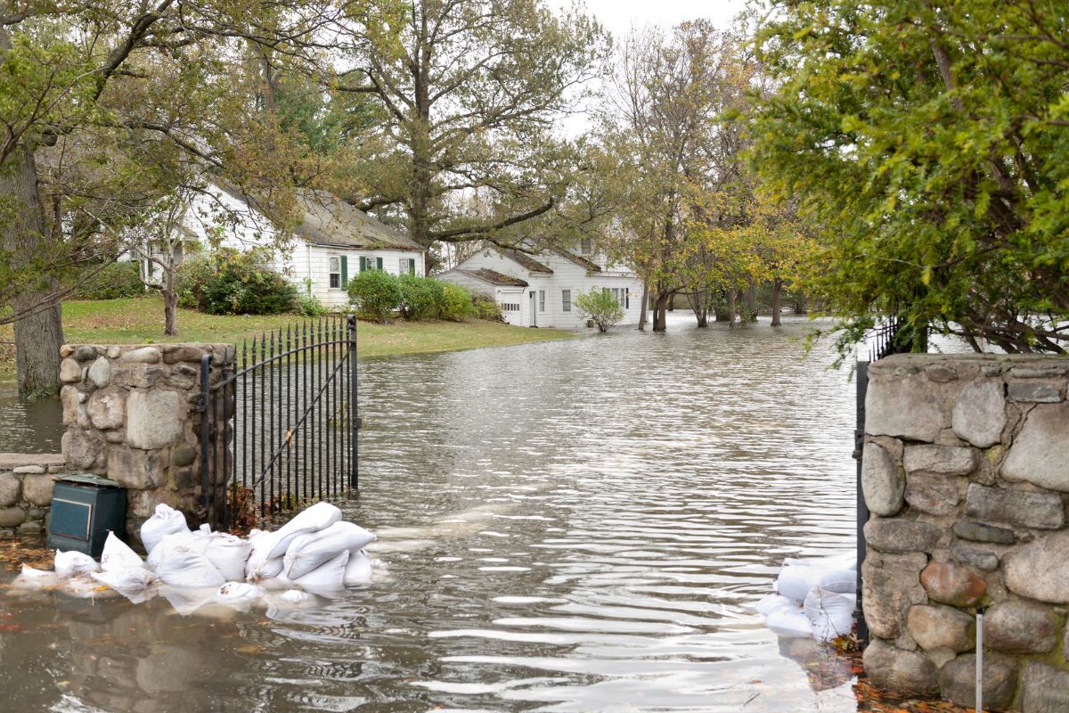 Flooding in front yard due to poor drainage systems, contributing to groundwater flow in Brambleton, VA causing water damage.
