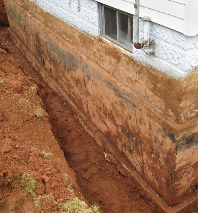 Foundation on uneven terrain causing slope erosion that needs foundation repair solutions in Berryville, VA.
