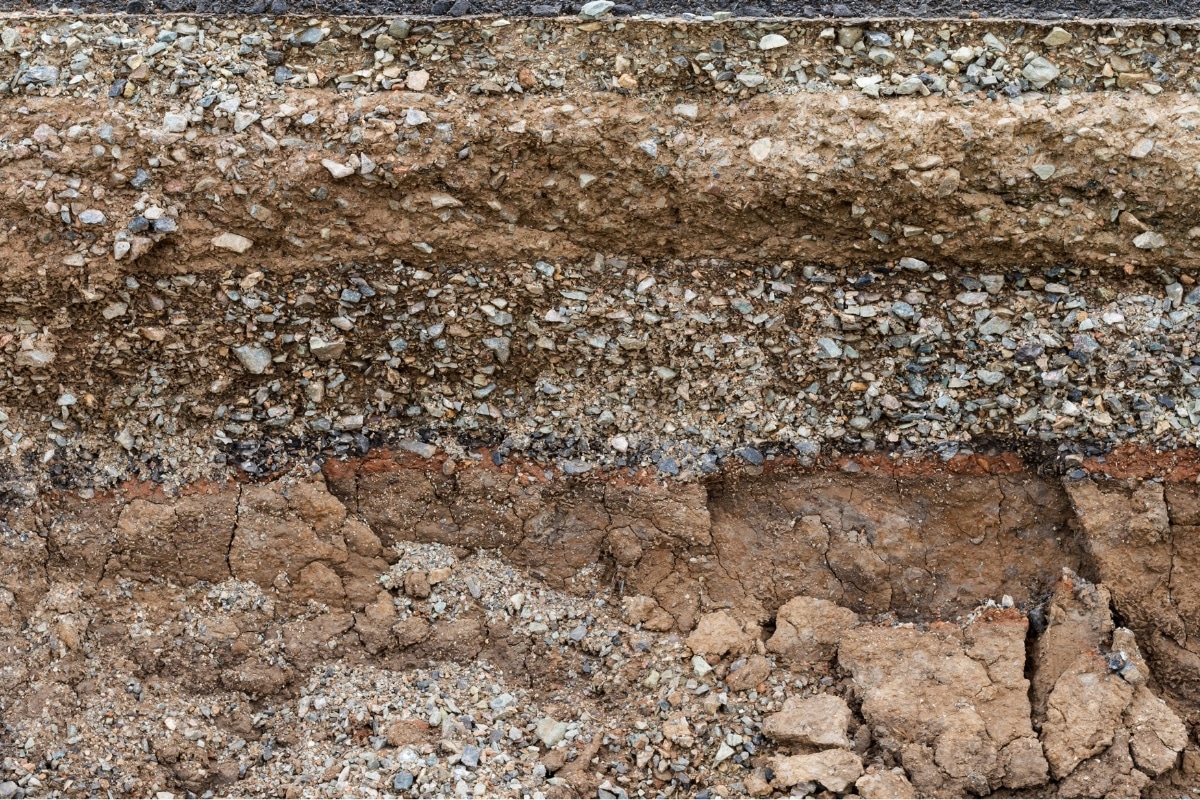 Soil layers beneath a foundation show soil changes contributing to settlement in Manassas, VA, causing foundation damage.
