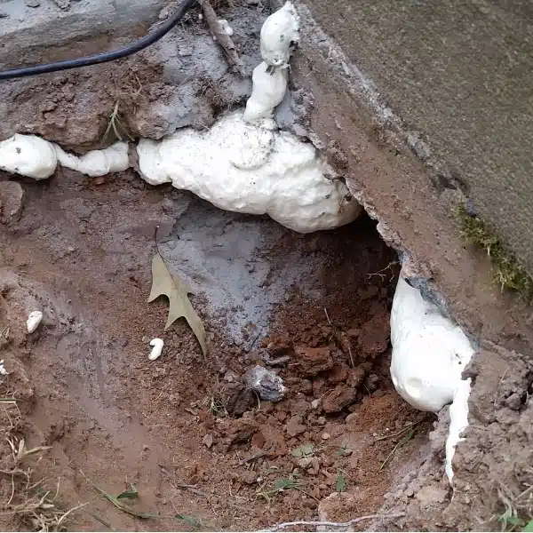 Large void beneath a foundation with polyurethane foam, ensuring long-term stability from soil settlement in Berkeley WV.