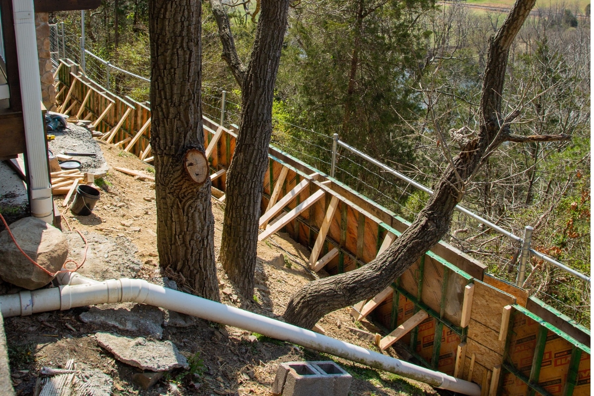 Foundation on steep terrain showing risks of soil shifting and slope erosion in Stephens City, VA, after heavy rainfall.