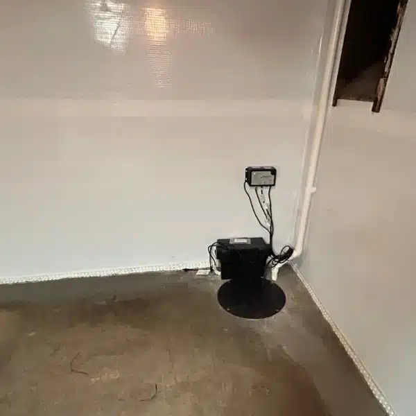 A sump pump installed in a basement to remove water and protect against flooding caused by slope failure in Martinsburg, WV.