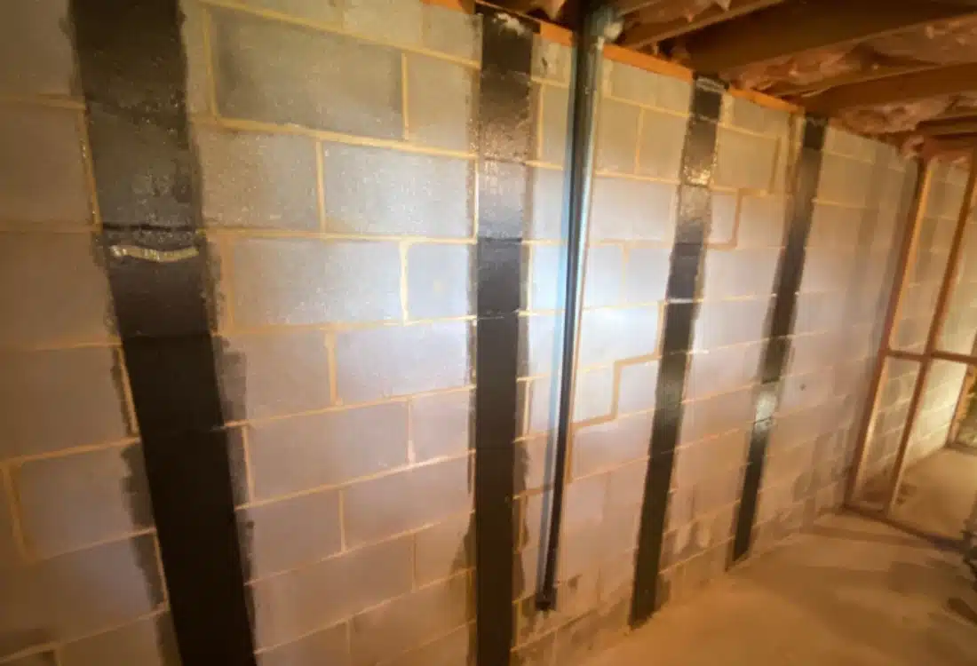 Stabilized foundation after stair-step foundation cracks carbon fiber repair in Winchester, VA, showing sealed cracks and stable walls.