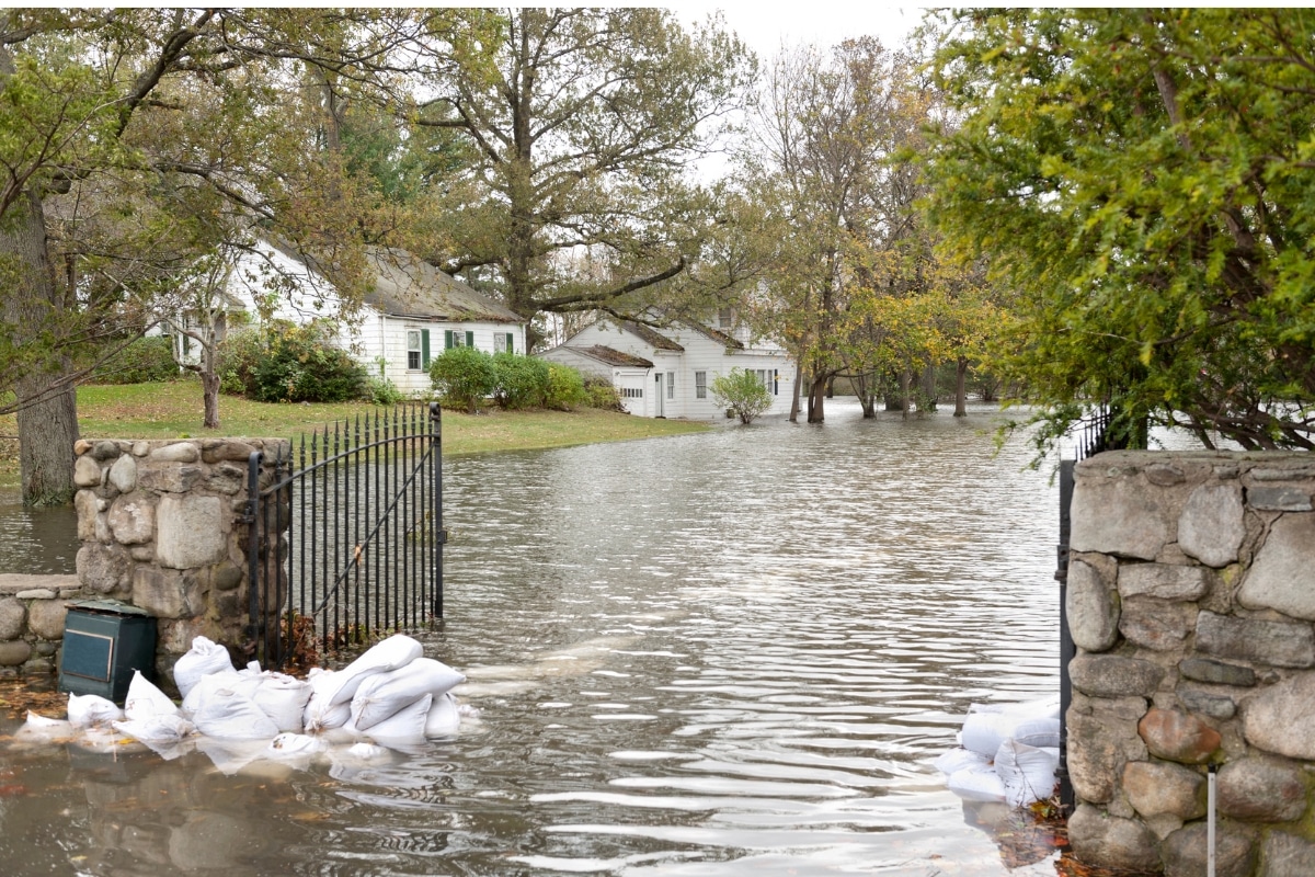Flooded yard eroding the soil beneath a home, highlighting foundation damage caused by natural disasters in Ashburn, VA.