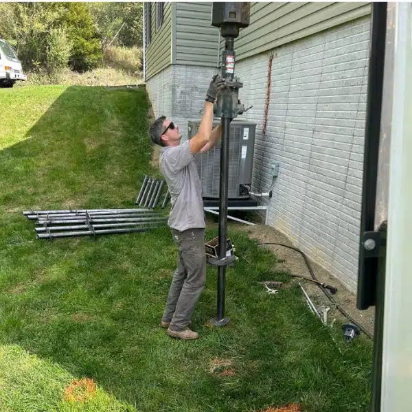 LUX team installing push piers to stabilize the foundation, addressing exceeding support capacity issues in Front Royal, VA.
