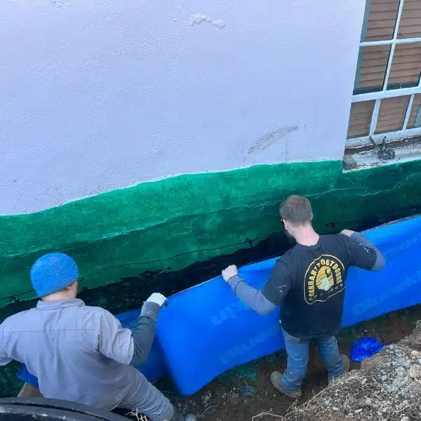 LUX team installing waterproofing membrane to protect foundation wall from infiltration of excessive moisture in Fairfax, VA.