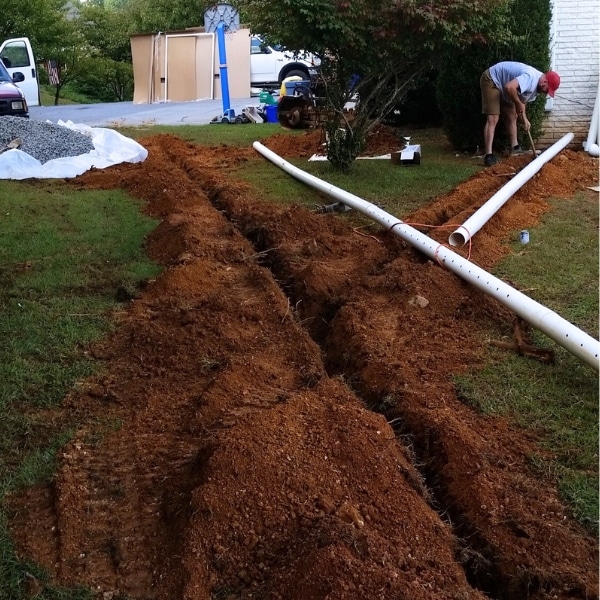 French drain installation, redirecting water away to resolve water damage from inadequate drainage in Front Royal, VA.