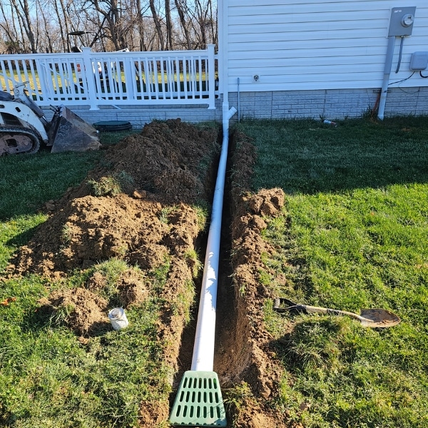 Extended downspout to control crawl space humidity and prevent high moisture levels in Fairfax, VA.