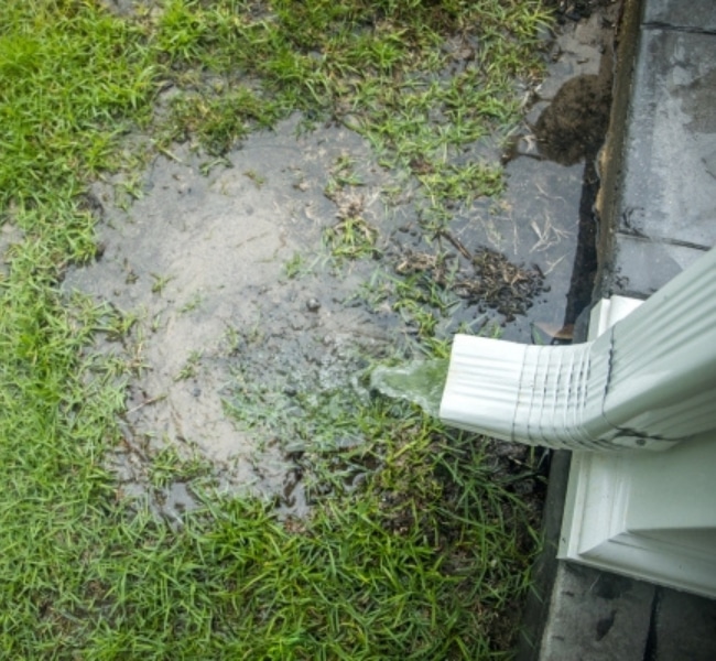 Water pooling near foundation due to inadequate drainage that needs repair solutions in Bristow, VA