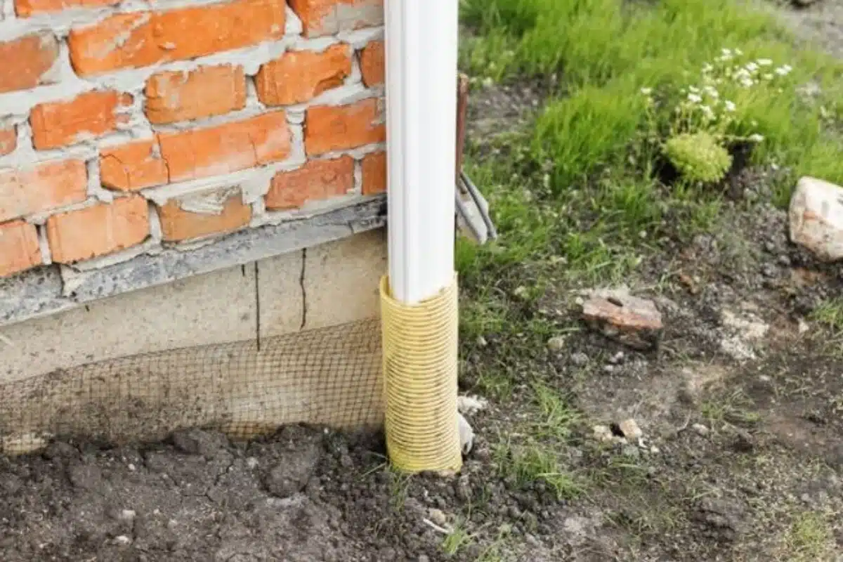 Foundation with cracks and unstable soil from inadequate soil preparation, a poor construction practice in Southbridge, VA.