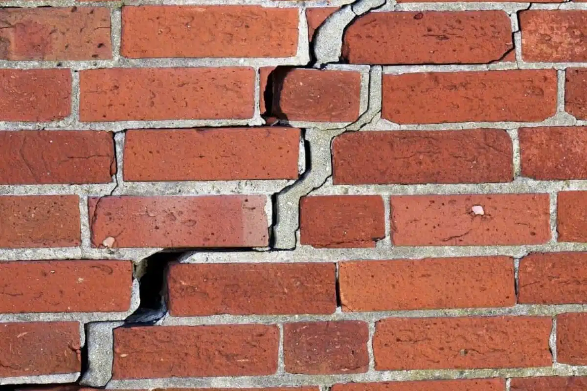 Cracked brick foundation wall caused by lack of proper supervision, highlighting poor construction practices in Linden, VA.