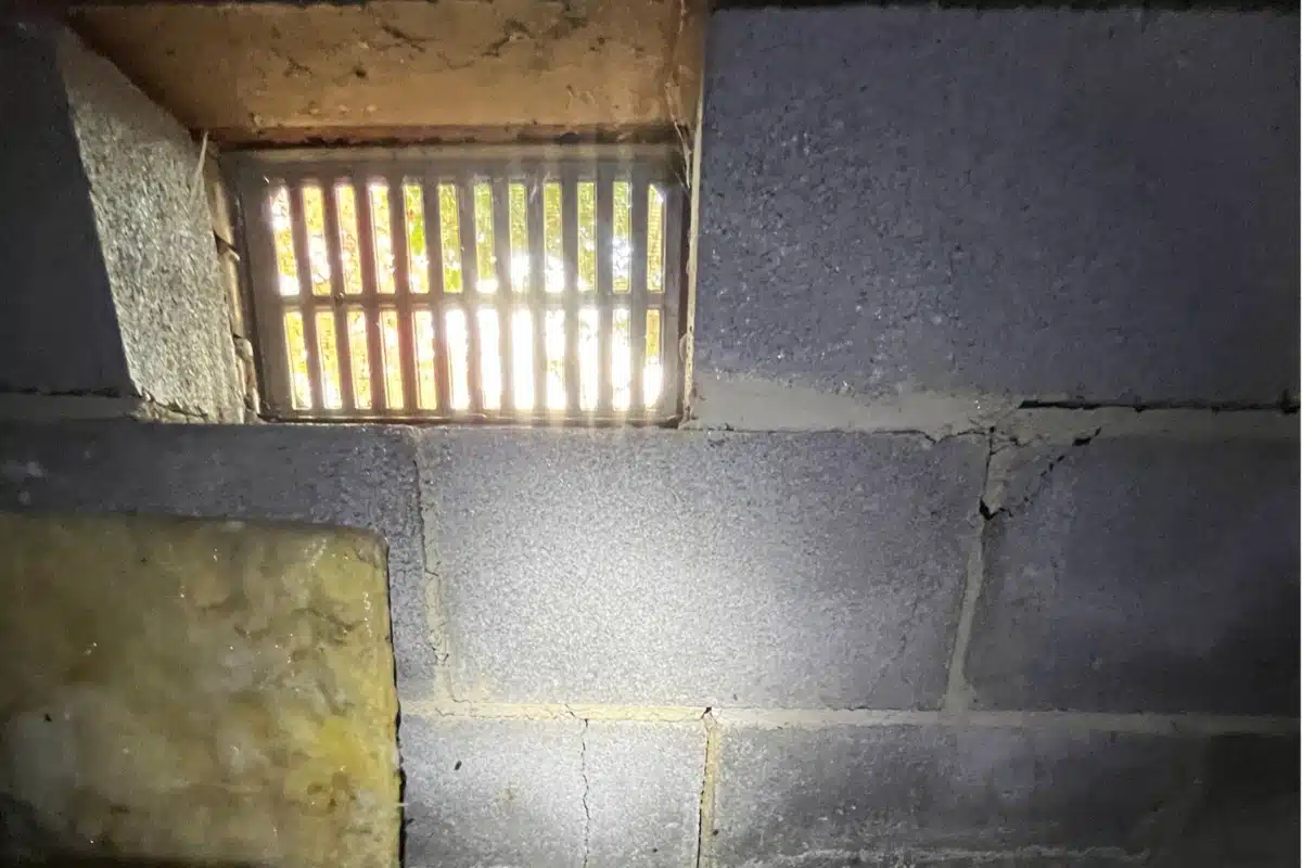 An open crawl space vent that allows outside air, causing high moisture levels in Manassas, VA.