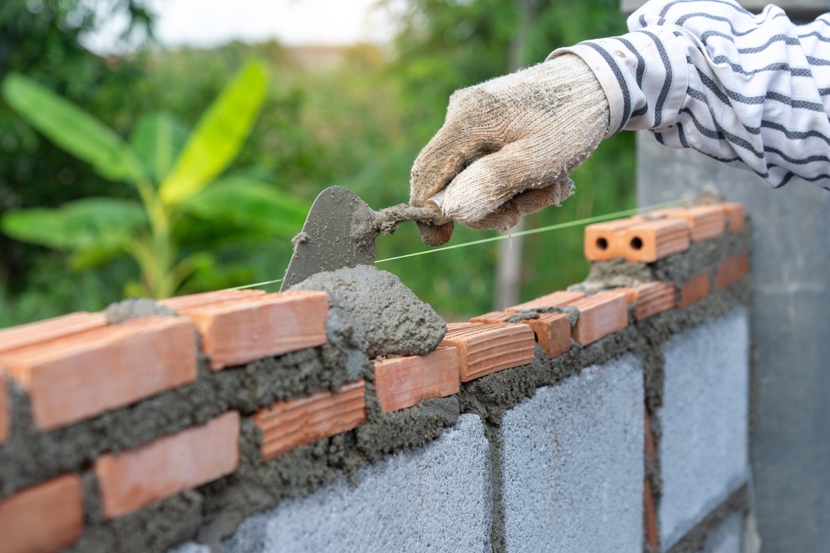 Unskilled workers incorrectly installing brick walls, showing poor workmanship and construction practices in Berkeley, WV.