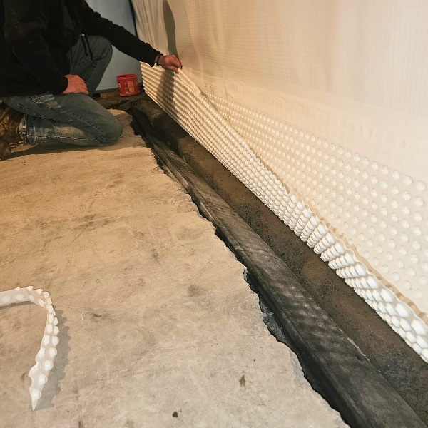 Installation of interior drainage system to waterproof the foundation wall from excessive moisture in Clear Brook, VA.