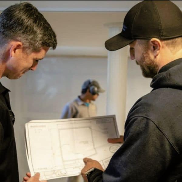 LUX team discussing building plans to avoid poor construction practices for a structurally sound home in Flint Hill, VA.