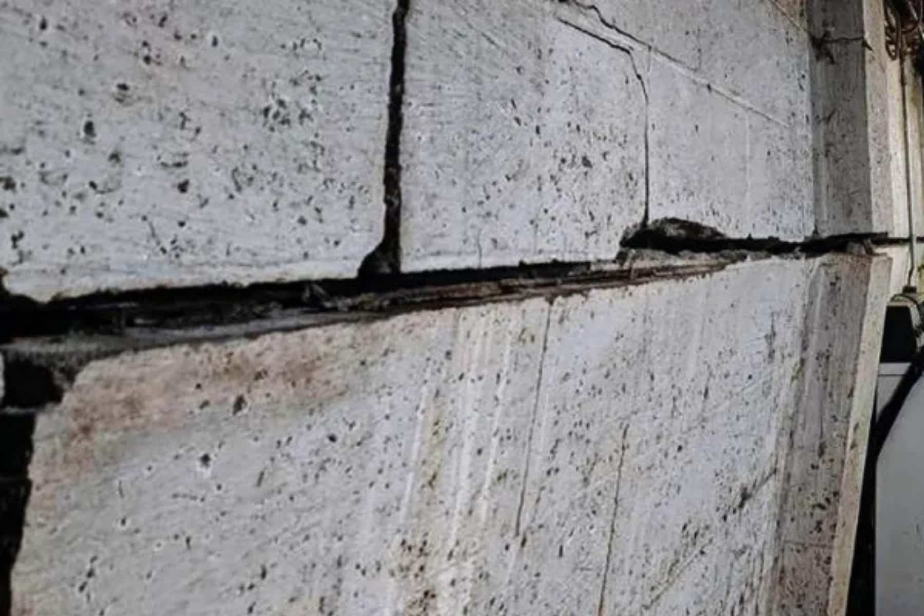Severe bowing and wide cracks in foundation wall caused by soil expansion during heavy rainfall in Berryville, VA, needing repair.