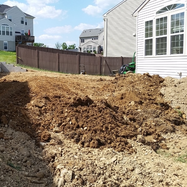 Regraded soil around a home’s foundation to ensure proper water flow away and stop excessive moisture in Harpers Ferry, WV.