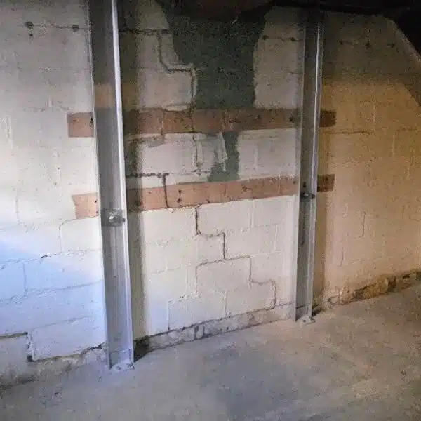 I-beam wall stabilizer installed on a compromised foundation wall to address damage from poor construction in Bristow, VA.