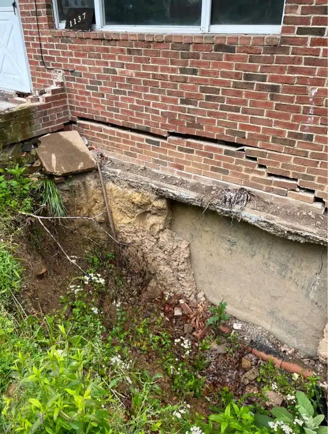 Crawl space foundation with cracks and uneven settling from soil expansion and contraction needing repair in Flint Hill, VA.