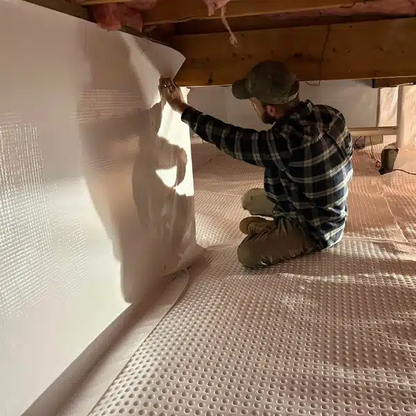 LUX team installing vapor barriers for expert crawl space repair services in Fairfax, VA, to address moisture issues.