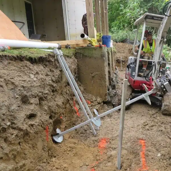 Helical piers installation to prevent crawl space foundation damage from counter expansive soil movement in Brambleton, VA.