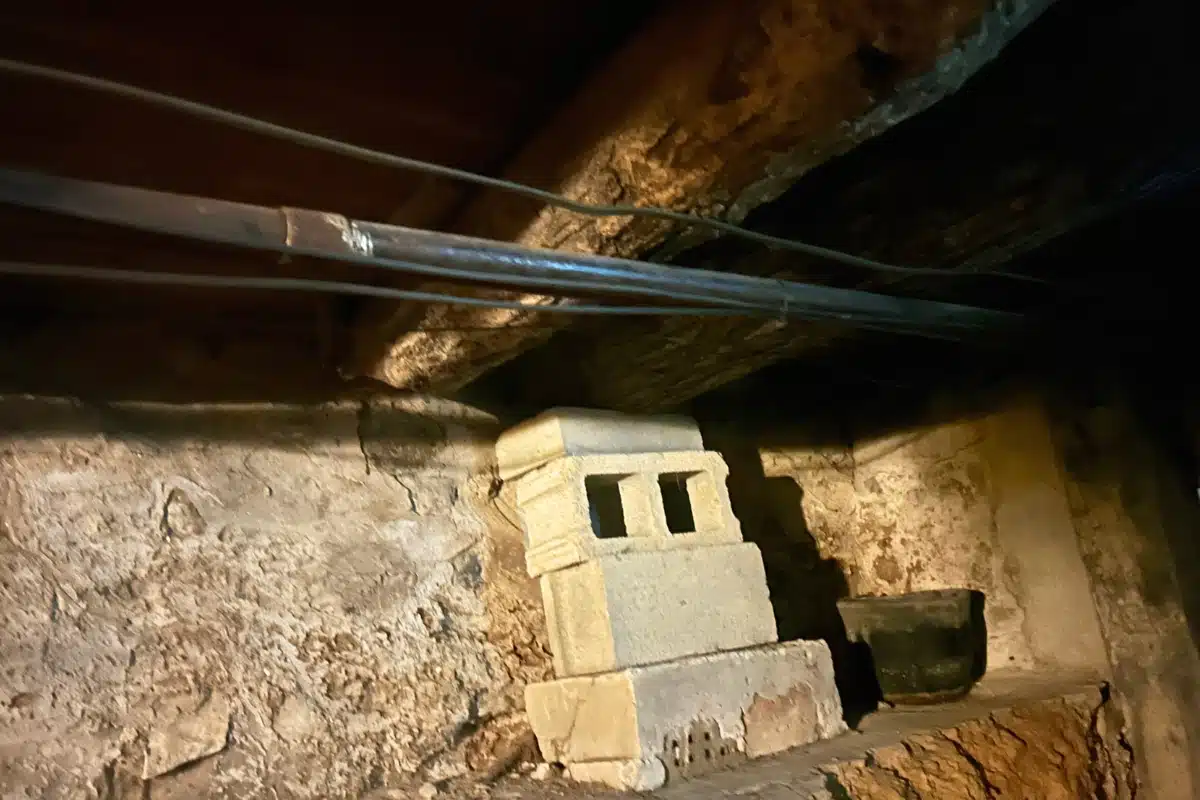 Crawl space with uneven cinder block posts, showing how poor installation caused improper crawl space support system in Clear Brook, VA.