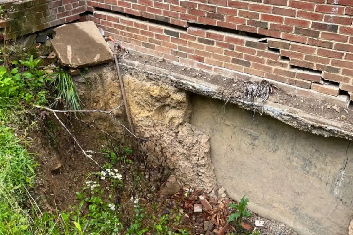 Crawl space foundation with cracks and erosion caused by seasonal moisture changes impacting expansive soil in Berkeley, WV.