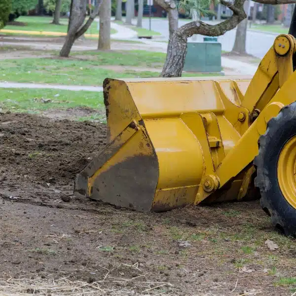 Bulldozer leveling soil for proper grading, a solution to prevent crawl space issues caused by expansive soil in Bristow, VA.