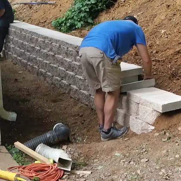 LUX team installing retaining walls, stabilizing shifting soil to prevent crawlspace issues from poor support systems in Brambleton, VA.