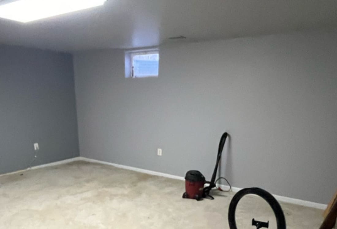 Basement with water stains and intrusion before sump pump installation in Berkeley, WV.