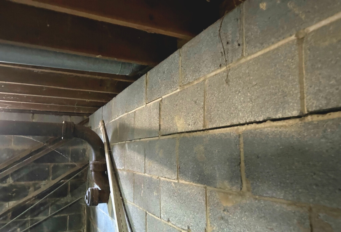 Horizontal cracks in the basement wall, indicating the need for carbon fiber straps foundation repair in Stephens City, VA.