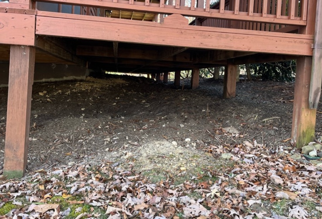 Rotted and unstable deck support posts in Charles Town, WV, compromising structural integrity due to moisture.